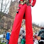 red & gold Christmas stilt walker