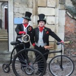 dickensian entertainers with penny farthings