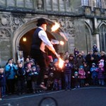 fire juggling show with tall unicycle