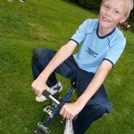 child on mini bike at circus skills workshop