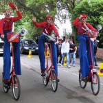 stilt walkers on bikes