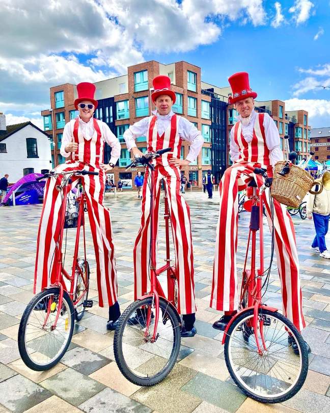 stilt walkers on bikes