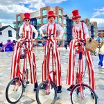 stilt walkers on bikes