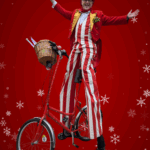 christmas stilt walker on a stilt bike
