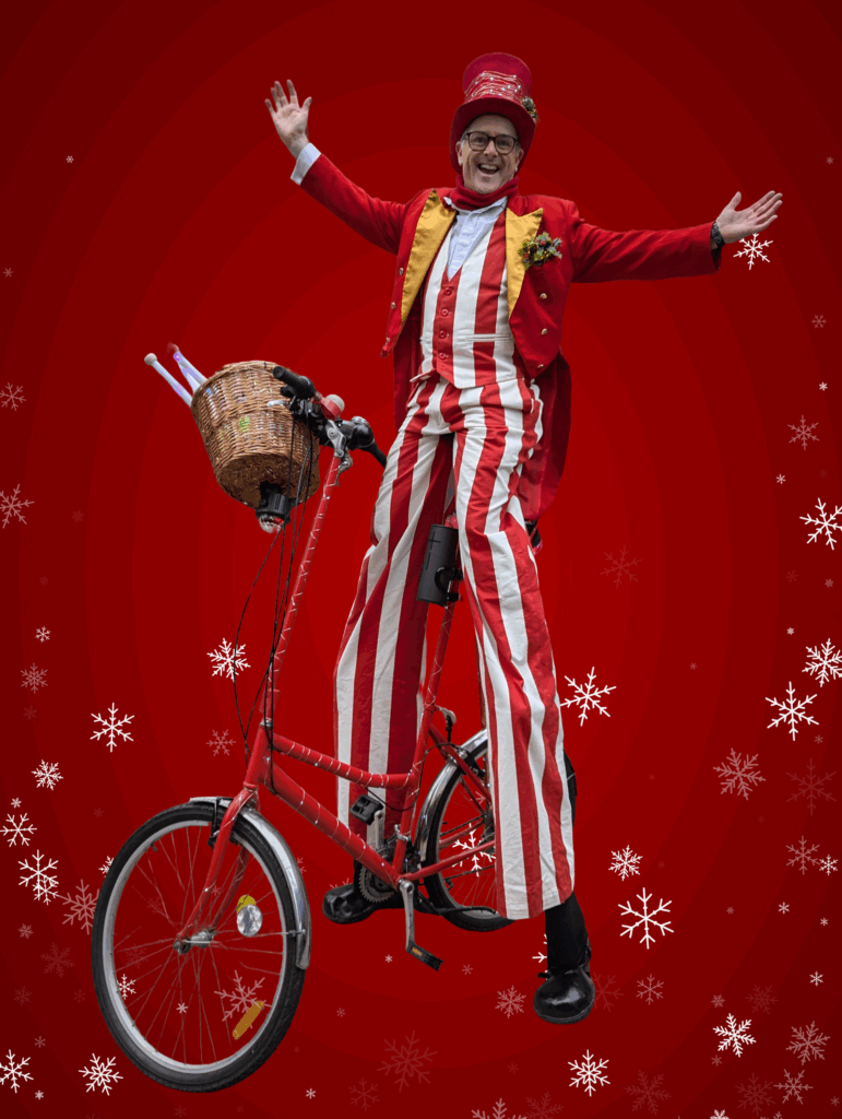 christmas stilt walker on a stilt bike