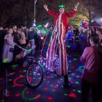 light up stilt walker on a stilts bike