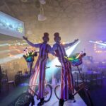 stilt walkers on bikes at corporate event
